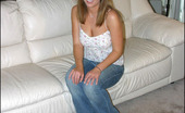 Club GND 555706 Mandy Mandy Relaxes On The Couch In A Cute Flower Top And Tight Jeans Club GND
