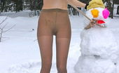 ePantyhose Land 560833 Katrine Stunning Chick In Flesh-Colored Pantyhose Making Snowman In Winter Forest ePantyhose Land
